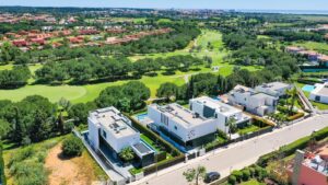 a bird's eye view of a golf course and houses