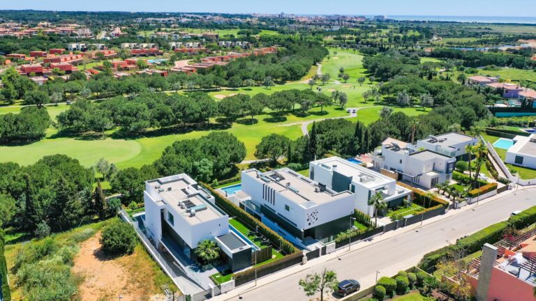 a bird's eye view of a golf course and houses